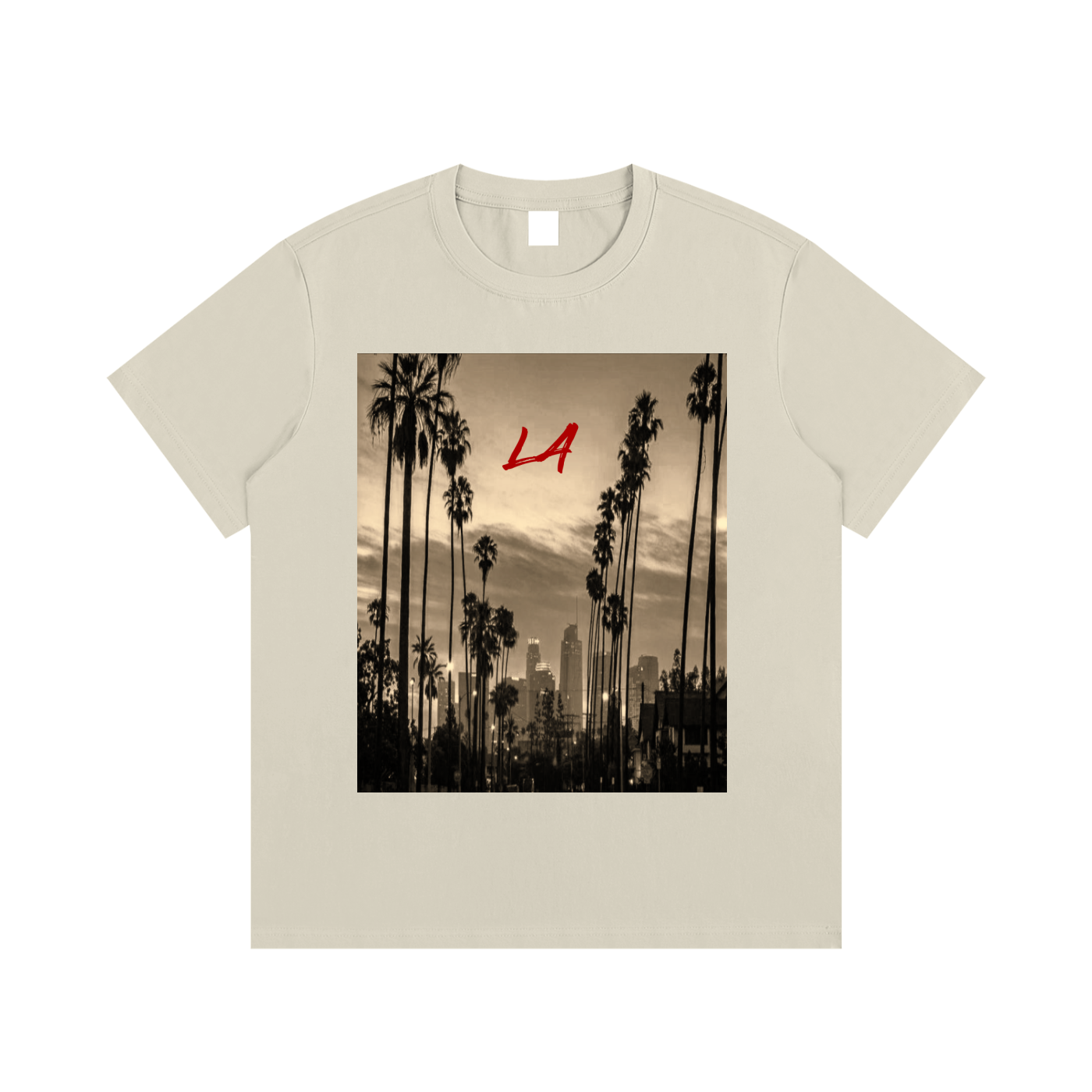 Beige t-shirt with a graphic of palm trees and a city skyline, featuring the letters 'LA'.