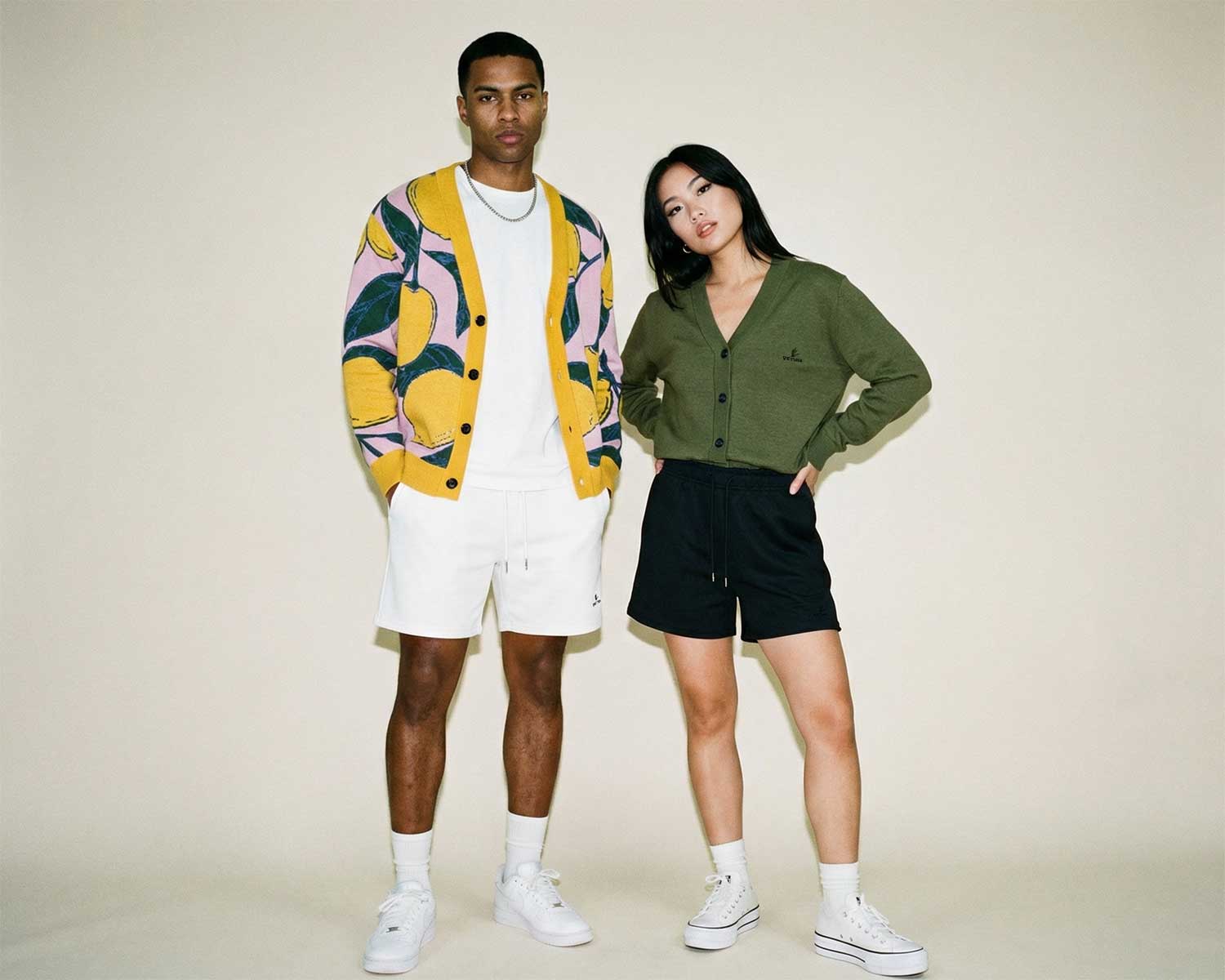 Two people standing side by side against a plain background