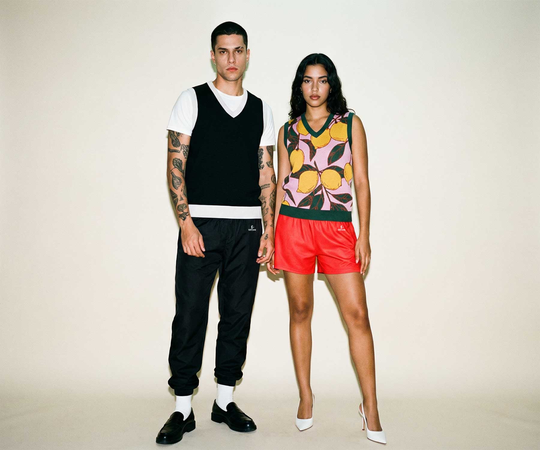 Two people standing side by side against a plain background