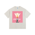 Beige t-shirt with a pink square featuring a white tulip and the word 'GROW' on a white background.