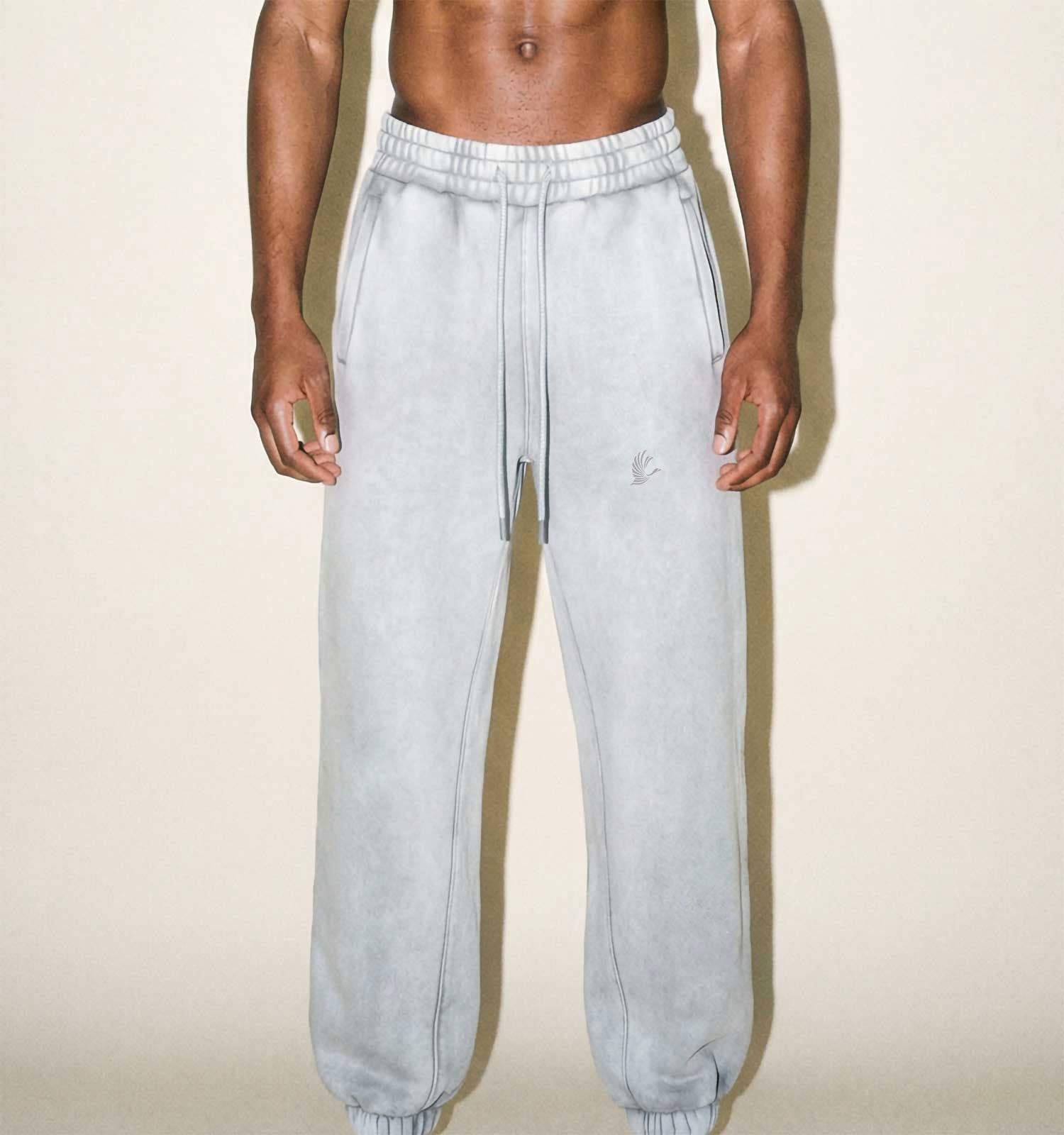 Light gray sweatpants worn by a person on a beige background